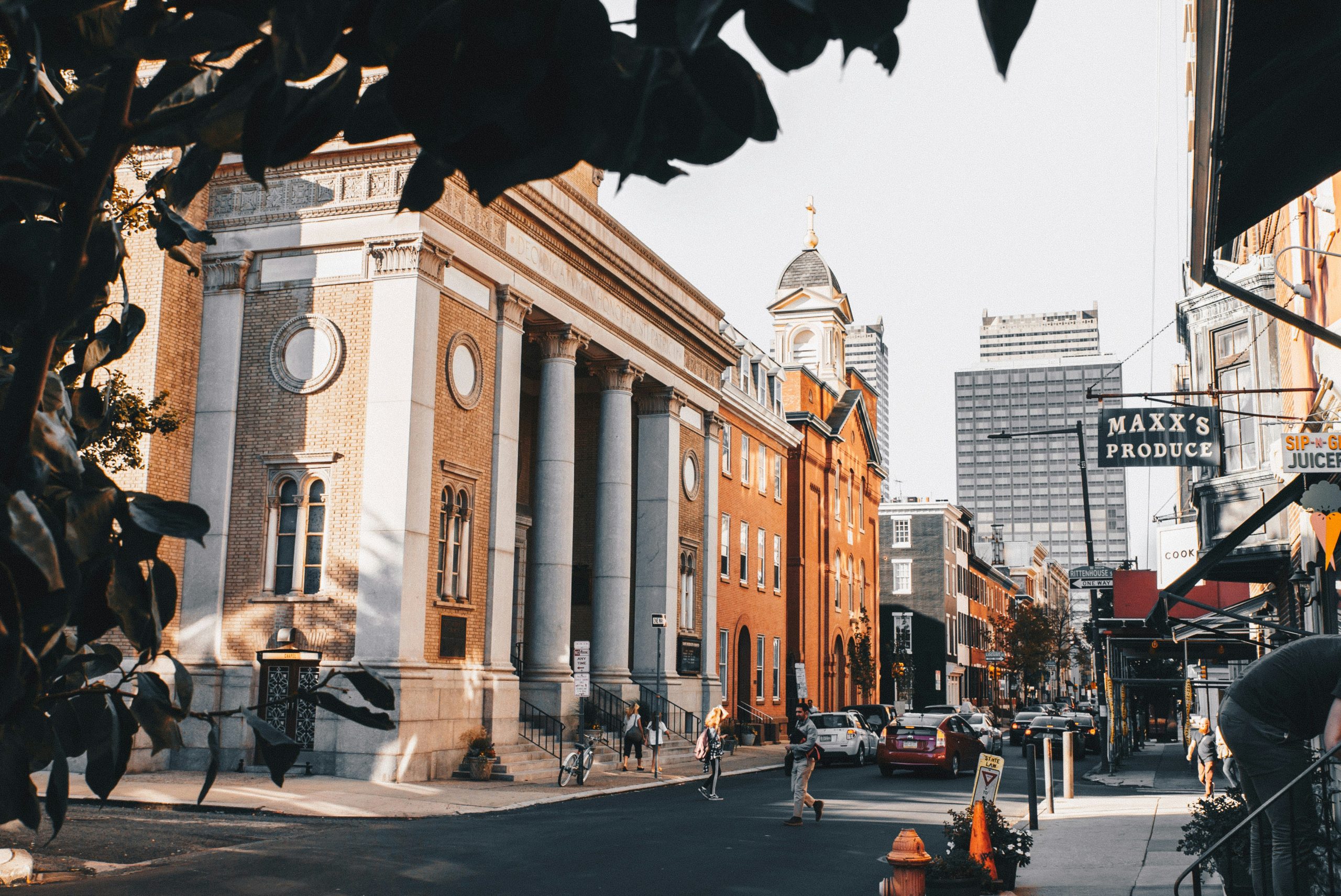 Street view of classical architecture with columns and pedestrians on the sidewalk in Philadelphia